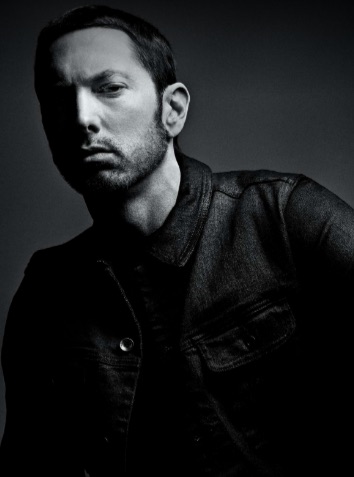 Eminem von der Hüfte aufwärts fotografiert. Er trägt eine schwarze Lederjacke.