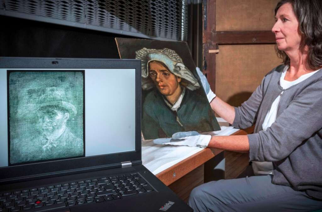Eine Frau hält ein Bild hoch und auf ihm Computer ist ein zweites Bild zu sehen.