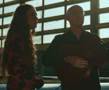 Jack Steadman mit einer Gitarre neben Holly Humberstone.
