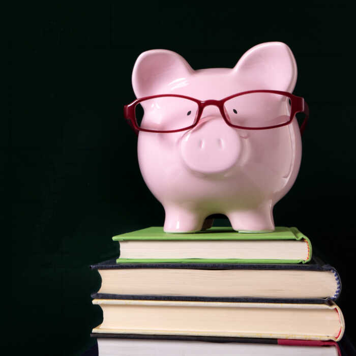 piggy-bank-glasses-books-blackboard