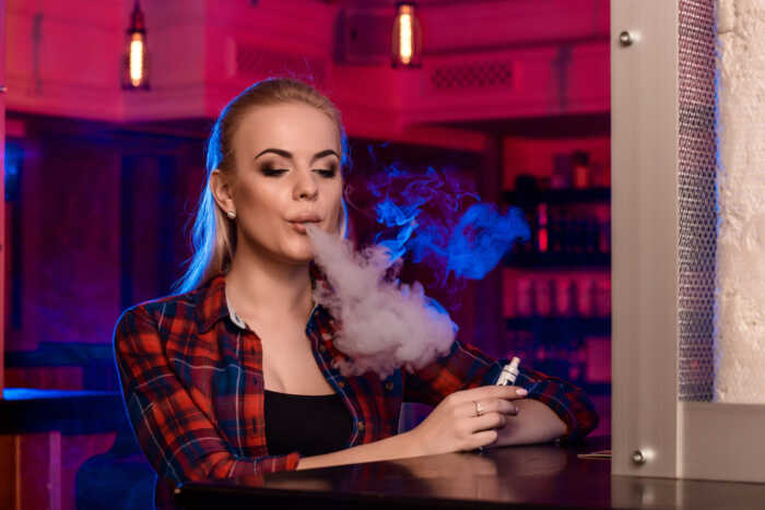 young-pretty-woman-shirt-cage-smoke-electronic-cigarette-vape-bar-vape-shop