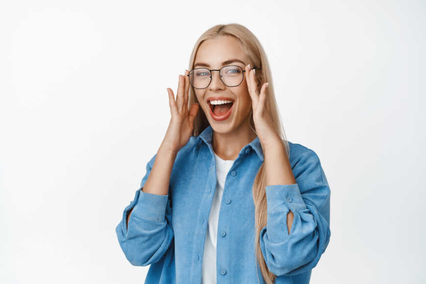 beautiful-blond-woman-put-glasses-laughing-smiling-with-happy-face-expression-standing-blue-shirt-white