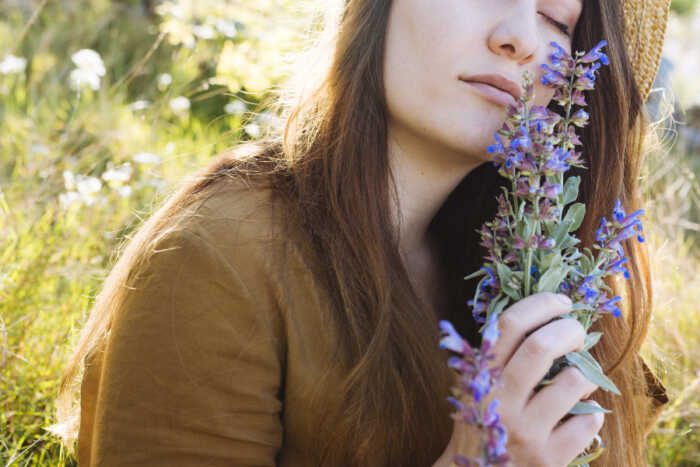 side-view-woman-holding-smelling-bouquet-flowers