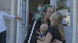 Benni und Nici küssen sich und halten ihr Baby. Sie sind eines der vier Paare die in der Doku begleitet werden.