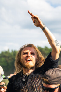 Ein Fan in der ersten Reihe singt mit und springt in die Luft.